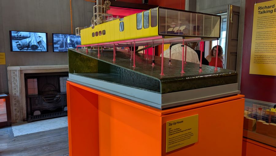 Model of a square building on stilts over water