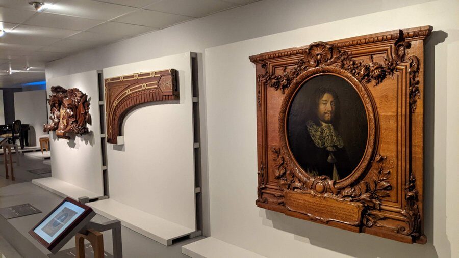 Wooden framed paintings and woodwork displayed on a wall