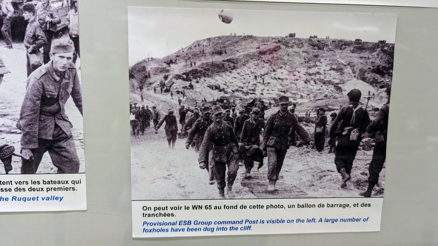 Photo of German POWs being marched up the hill from Omaha Beach
