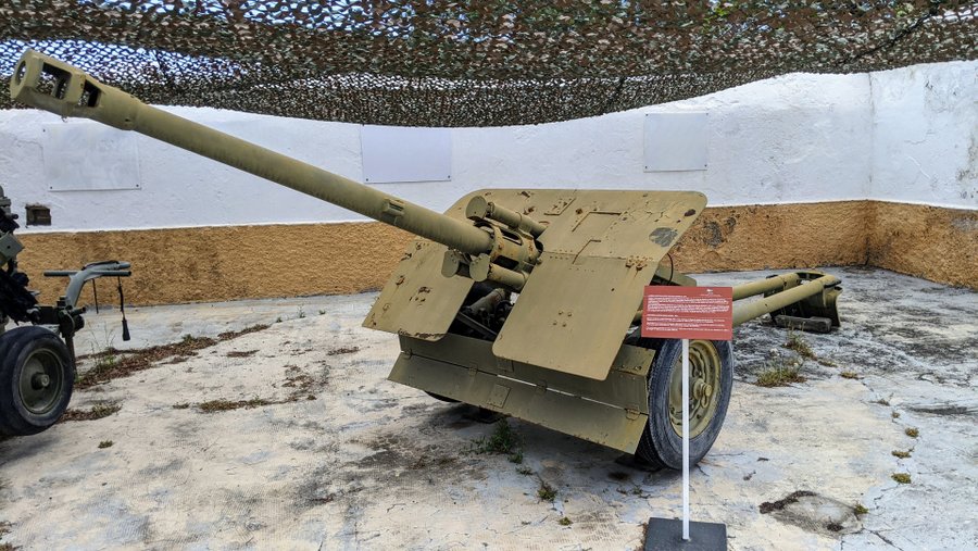 A light brown anti-tank gun with a long barrel and sloping armour