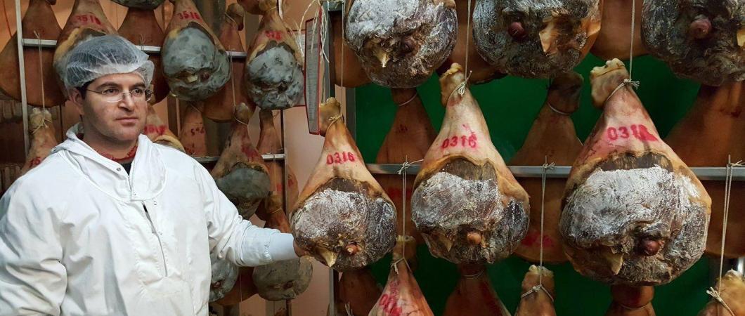 Manager stand with dried hams in storage racks