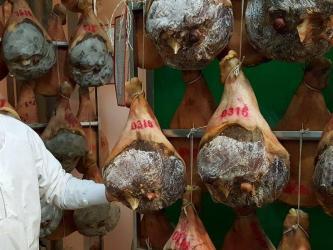 Manager stand with dried hams in storage racks