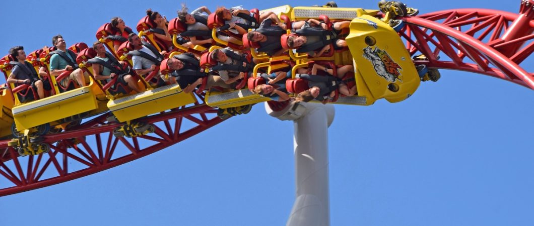 People on a roller-coaster hanging upside down as their cart spins