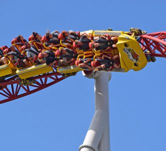 People on a roller-coaster hanging upside down as their cart spins